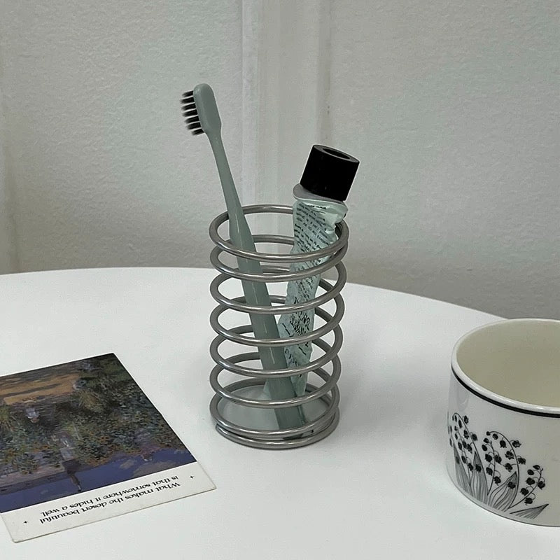 Spring brush stand